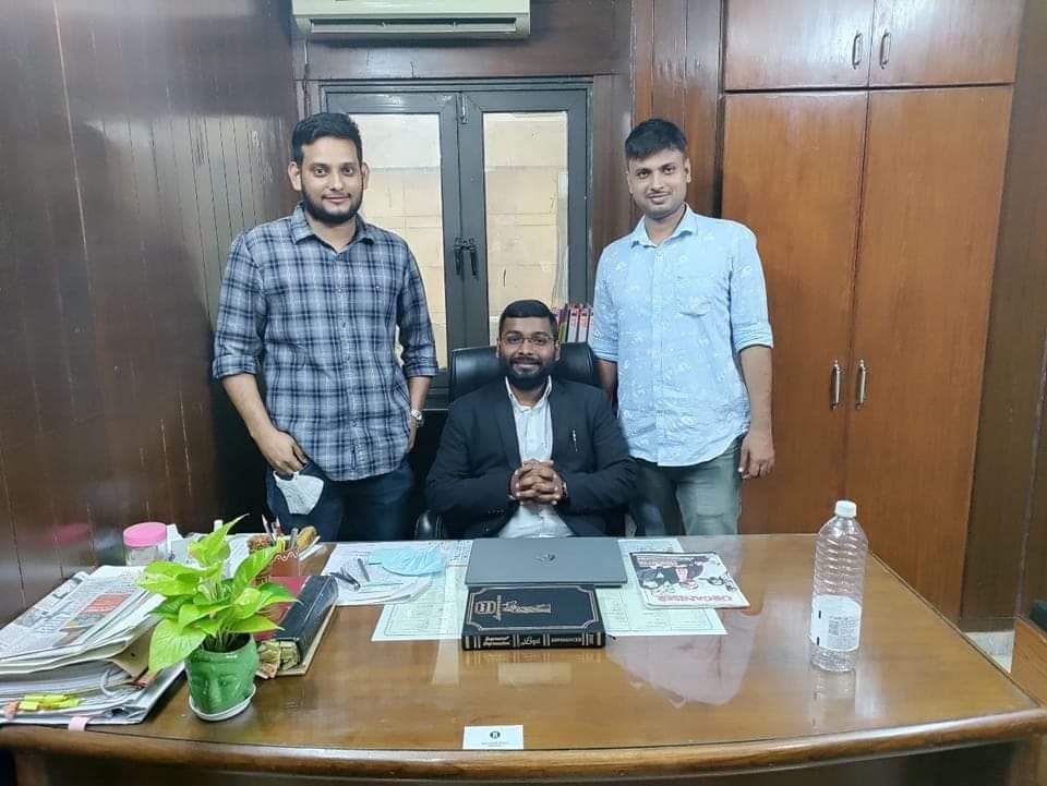 Advocate Shubham Singh seated at chamber desk conducting case briefing with associates
