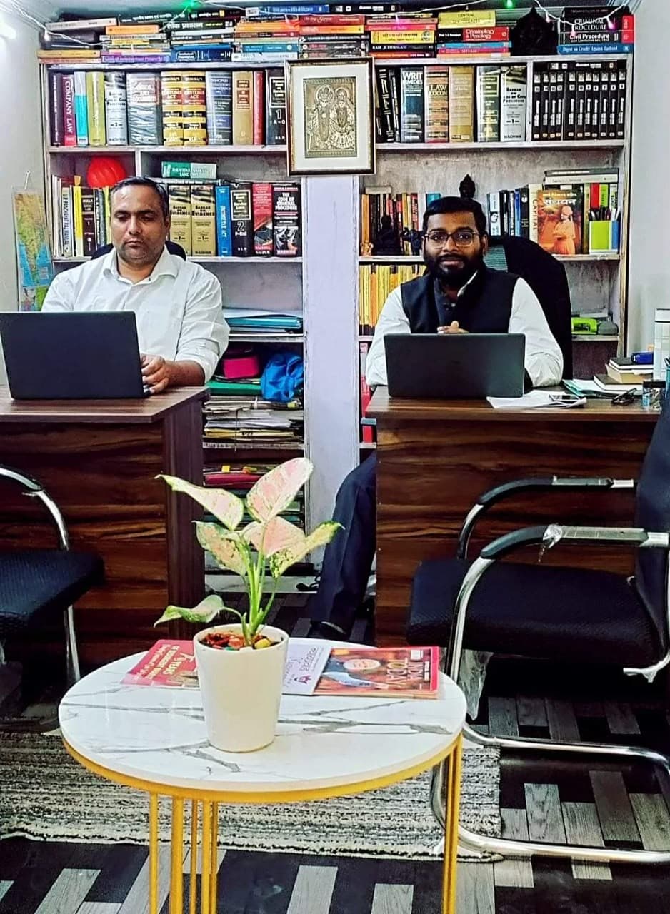 Advocate Shubham Singh and legal associate researching case law in chambers library