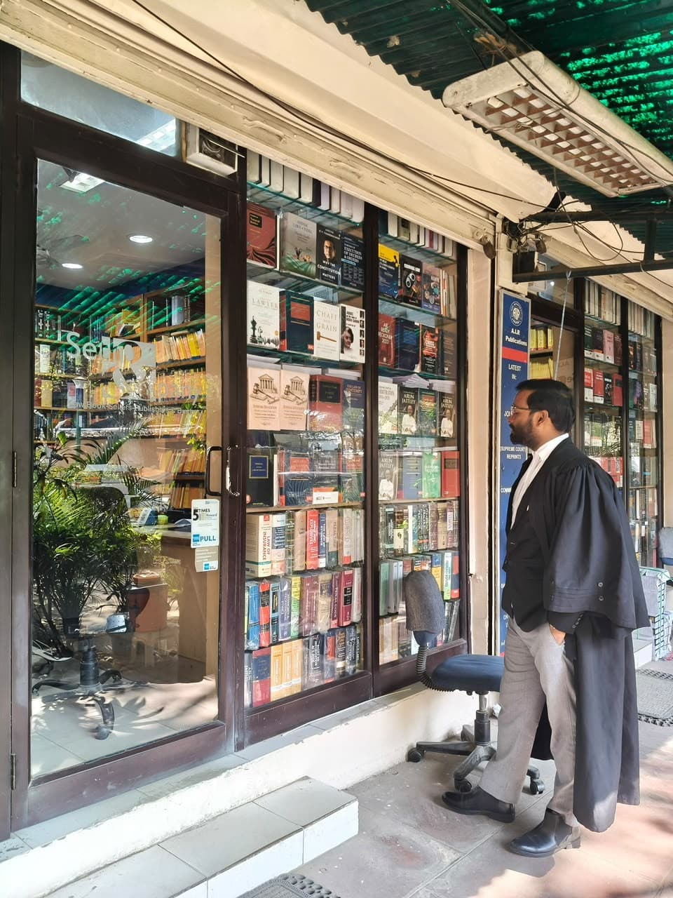 Advocate Shubham Singh in court dress outside Seth & Co. Law Book Sellers